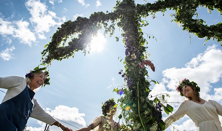 People dancing around a may pole