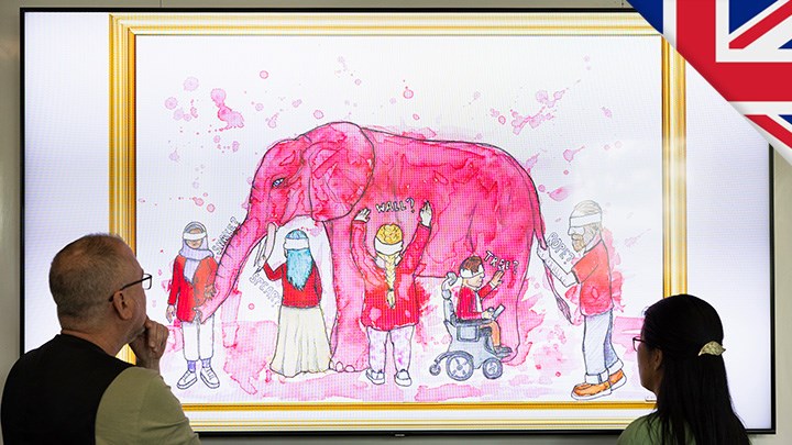 A man and woman look at a painting with a pink elephant that five cartoon people examine. There is a British flag in the right corner.