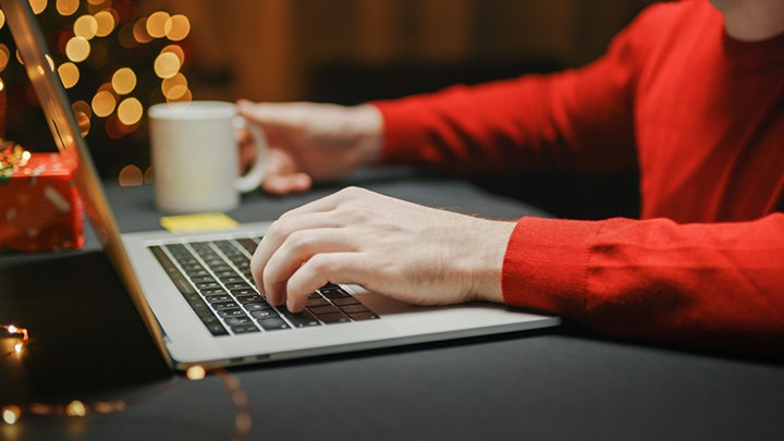 Photo of hands typing on a keyboard.