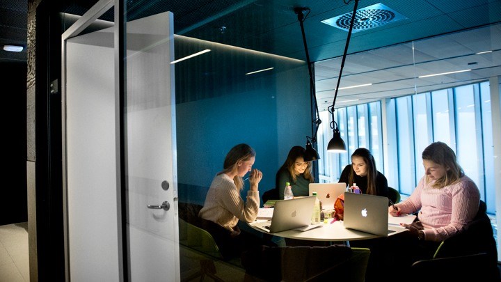 Four persons sitting in a group study room