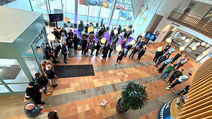 A view from above of visitors to an indoor exhibition.