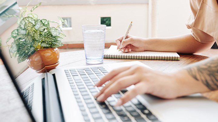 Photo of a person typing on a computer.