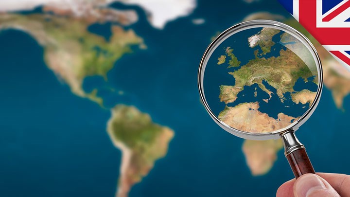 A map of the world, with a magnifying glass of Europe.