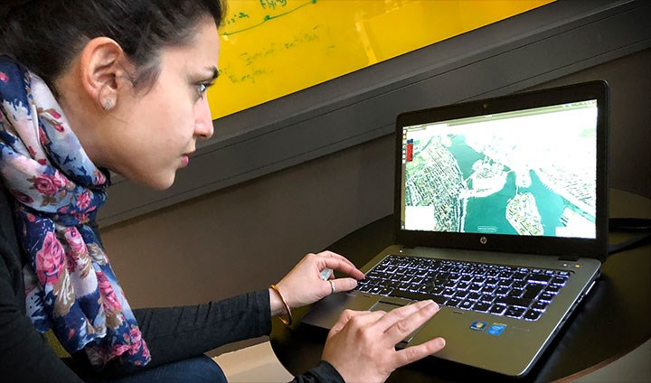 Marjan Alirezaie typing on a laptop keyboard