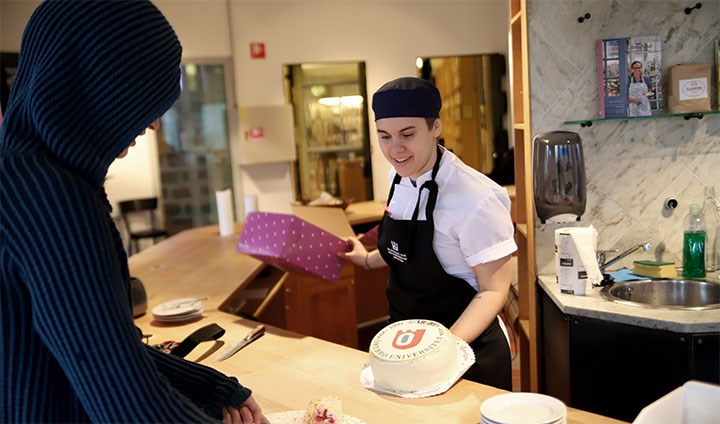 Studenten Louise Troedsson dukar fram en tårta.