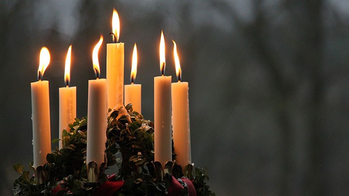 A Lucia crown with seven burning candles.