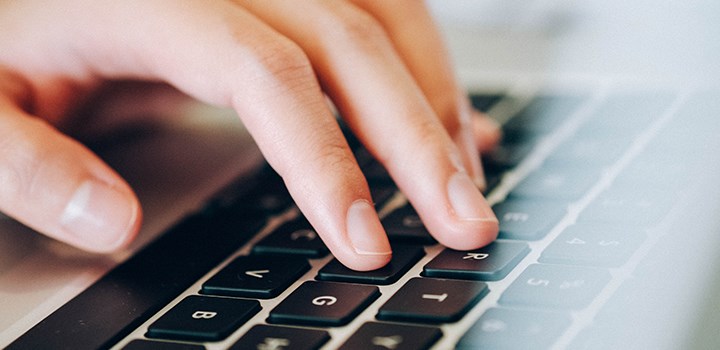 Photo of hand on laptop