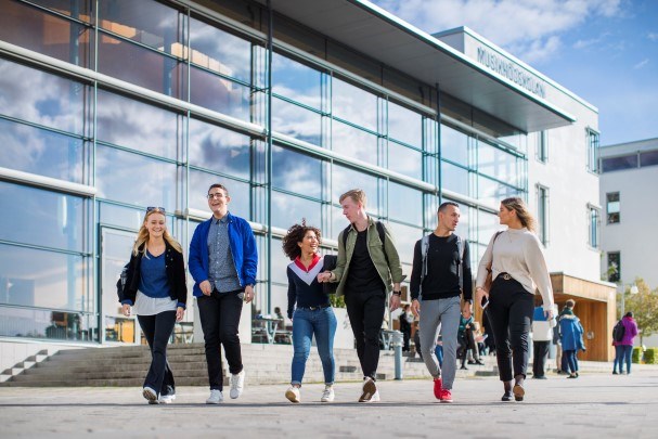 En grupp studenter går utanför musikhögskolans byggnad.